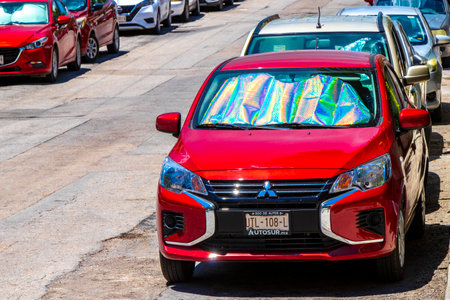 Various cars parked outside on the roadside in Playa del Carmen Quintana Roo Mexico.のeditorial素材