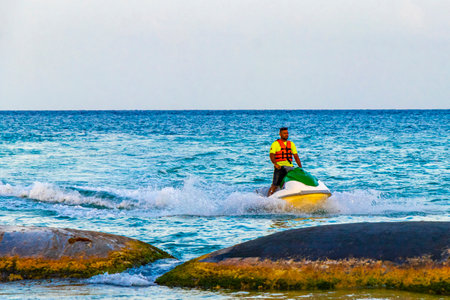 Hire a jet ski and enjoy water sports on the Caribbean beach in Playa del Carmen Quintana Roo Mexico.のeditorial素材