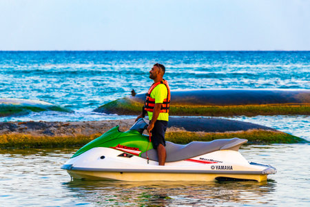 Hire a jet ski and enjoy water sports on the Caribbean beach in Playa del Carmen Quintana Roo Mexico.のeditorial素材