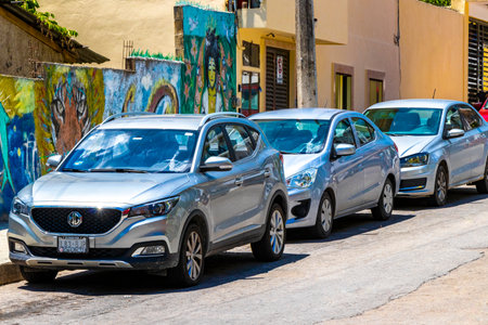 Various cars parked outside on the roadside in Playa del Carmen Quintana Roo Mexico.のeditorial素材