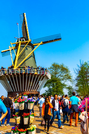 Lisse South Holland Netherlands April 4, 2014 Old beautiful wooden mill with people tourists in Keukenhof Lisse South Holland Netherlands Holland in Europe.のeditorial素材