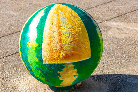 Decorative stone rock cement balls with graffiti painting on sidewalks in Playa del Carmen Mexico.のeditorial素材