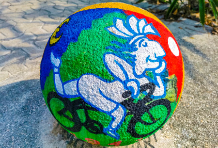 Decorative stone rock cement balls with graffiti painting on sidewalks in Playa del Carmen Mexico.のeditorial素材