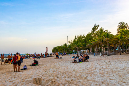 Tropical mexican caribbean beach and sea with people sun loungers parasols resort turquoise water and waves in Playa del Carmen Quintana Roo Mexico.のeditorial素材