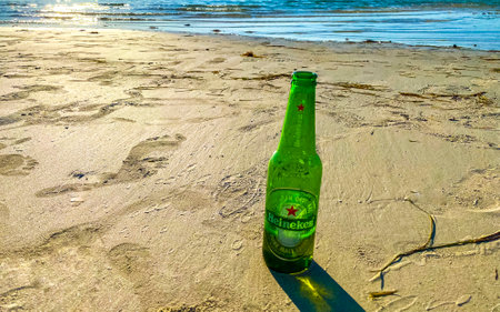 Holbox island in Quintana Roo Mexico May 16, 2022 Drinking a bottle of cold beer Heineken on the beach in paradise on Isla Holbox island in Quintana Roo Mexico.のeditorial素材