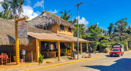 Mazunte Oaxaca Mexico November 23, 2022 Idyllic tourist street with restaurants houses people cars and hotels stores in Mazunte Oaxaca Mexico.のeditorial素材