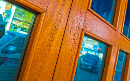 Beautiful lacquered wooden door texture pattern in Zicatela Puerto Escondido Oaxaca Mexico.のeditorial素材