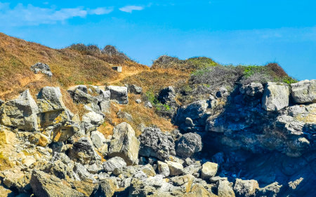Beautiful rocks cliffs stones and boulders on mountain with natural stairs on the beach in Zicatela...