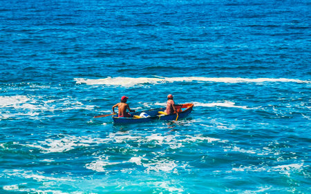Puerto Escondido March 25, 2023 Boat canoe with people in the pacific sea beach panorama view blue water waves in Puerto Escondido zicatela Oaxaca Mexico.のeditorial素材