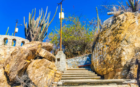 Beautiful rocks cliffs stones and boulders on mountain with natural stairs on the beach in Zicatela Puerto Escondido Oaxaca Mexico.の写真素材