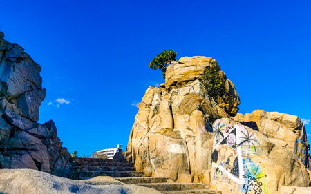Beautiful rocks cliffs stones and boulders on mountain with natural stairs on the beach in Zicatela...