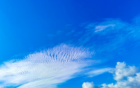 Blue sky with chemical cumulus clouds chemical sky scalar waves and chemtrails on sunny day in...