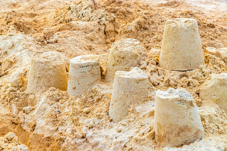 Castle made of white sand with buckets on the beach in Playa del Carmen Quintana Roo Mexico.