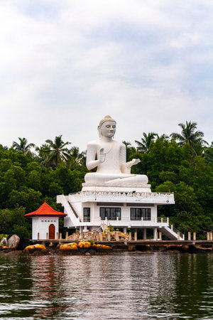 Large white Buddha statue in Bentota Udakotuwa Temple at Bentota Ganga in Bentota Beach Galle District Southern Province Sri Lanka.の写真素材