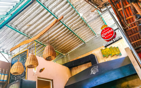 Interior of a restaurant bar with tables chairs decoration desk and plants in Playa del Carmen Quintana Roo Mexico.のeditorial素材