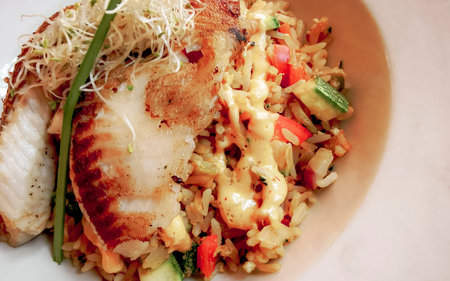 Grilled fish on rice vegetables and chipotle sauce dish meal in Playa del Carmen Quintana Roo Mexico.の写真素材