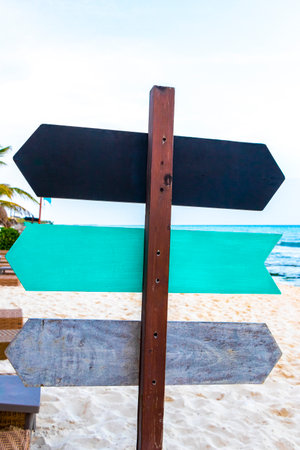 Black gray gray turquoise blank arrow arrows direction sign signs to write on beach in nature in Playa del Carmen Quintana Roo Mexico.の写真素材