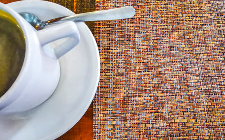 Glass pot cup of americano black coffee with spoon and plate on a table food and drink in the restaurant cafe in Playa del Carmen Quintana Roo Mexico.の写真素材