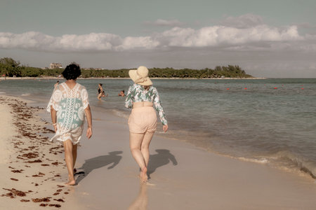 Tropical Mexican Caribbean beach and sea with a lot of fun people sun loungers parasols turquoise palms water in Playa del Carmen Mexico.のeditorial素材
