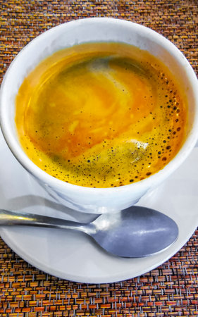 Glass pot cup of americano black coffee with spoon and plate on a table food and drink in the restaurant cafe in Playa del Carmen Quintana Roo Mexico.の写真素材