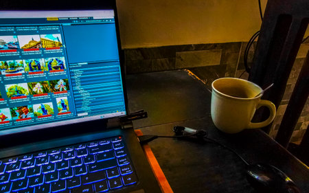 Laptop work at table with coffee cup at home office and cafe in Playa del Carmen Quintana Roo Mexico.のeditorial素材