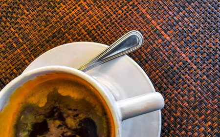 Glass pot cup of americano black coffee with spoon and plate on a table food and drink in the...