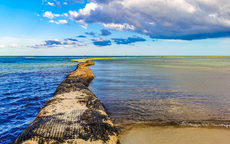 Path into the sea on a dike of stones and rocks in Playa del Carmen Quintana Roo Mexico.