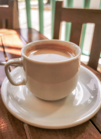 Glass pot cup of americano black coffee with spoon and plate on a table food and drink in the restaurant cafe in Playa del Carmen Quintana Roo Mexico.の写真素材