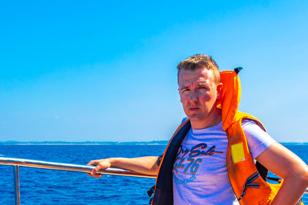Man tourist traveler on boat trip catamaran ship tour blue whale tourists people and sea ocean and...