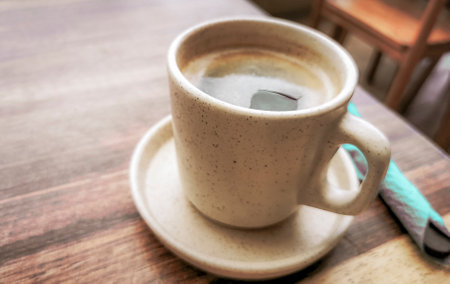 Glass pot cup of americano black coffee with spoon and plate on a table food and drink in the restaurant cafe in Playa del Carmen Quintana Roo Mexico.の写真素材