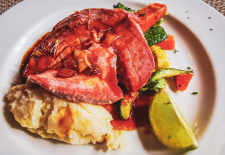 White plate with a fish fillet vegetable potato dish.の写真素材