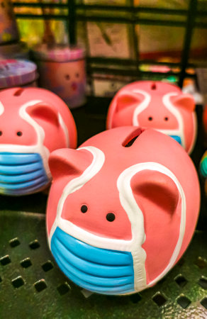 Piggy bank with medical protective face mask in Playa del Carmen Quintana Roo Mexico.の写真素材