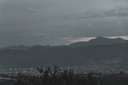 Beautiful sunset and night panorama view of the mountain landscape and city with forest trees clouds and nature in Central America.の写真素材