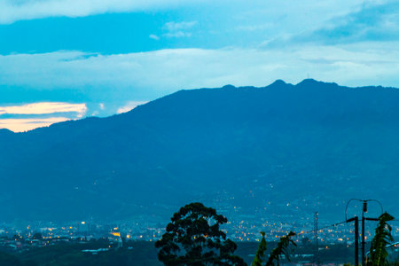 Beautiful sunset sunrise and night panorama view of the mountain landscape and city with forest trees clouds and nature of San JosÃ© and Heredia Costa Rica in Central America.の写真素材