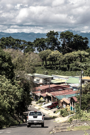 Village road and street through town natural land and forest with mountains in Para Heredia Costa Rica in Central America.の写真素材
