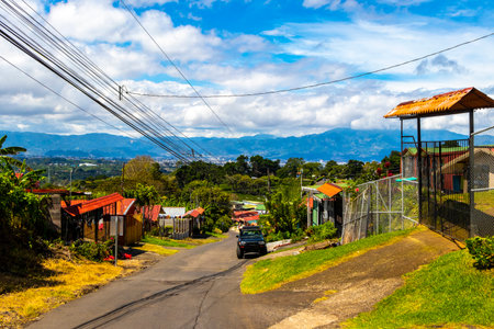 Village road and street through town natural land and forest with mountains in Para Heredia Costa Rica in Central America.の写真素材