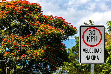 Road sign reduce speed white red in Para Heredia Costa Rica in Central America.の写真素材