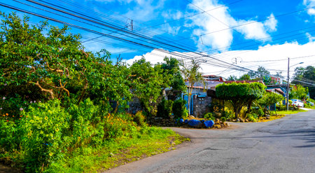 Village road and street through town natural land and forest with mountains in Para Heredia Costa Rica in Central America.の写真素材