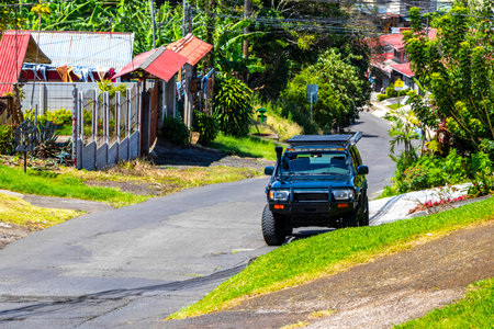 Village road and street through town natural land and forest with mountains in Para Heredia Costa Rica in Central America.の写真素材