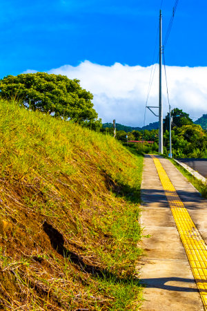 Village road and path through natural land and forest with mountains in Para Heredia Costa Rica in Central America.の写真素材