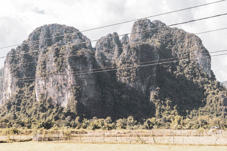 Mountain peak landscape with tropical forest jungle hills rocks and blue sky in Vang Vieng Vientiane Province Laos in Southeast Asia.の写真素材