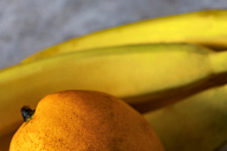Ripe juicy yellow mangoes and bananas fruit fruits on the table in Playa del Carmen Quintana Roo Mexico.の写真素材