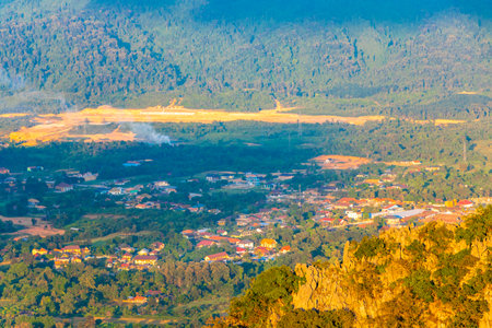 Mountain peak landscape with tropical forest jungle hills rocks fields and blue sky in Vang Vieng Vientiane Province Laos in Southeast Asia.の写真素材