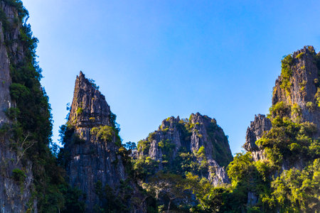Mountain peak landscape with tropical forest jungle hills rocks and blue sky in Vang Vieng Vientiane Province Laos in Southeastasia Asia.の写真素材