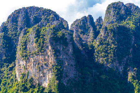 Mountain peak landscape with tropical forest jungle hills rocks and blue sky in Vang Vieng Vientiane Province Laos in Southeastasia Asia.の写真素材