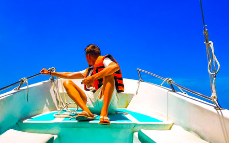Male tourist man on boat on the way to Holbox Island in Chiquila Lazaro Cardenas in Quintana Roo...