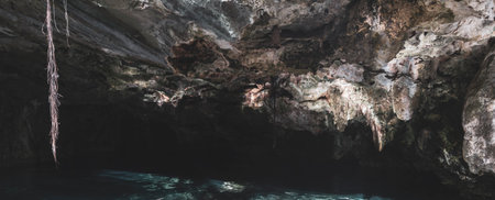 Beautiful Cenote Park Minotauro with limestone rocks turquoise blue green water and nature jungle around it in Xpu Ha Quintana Roo Mexico.の写真素材