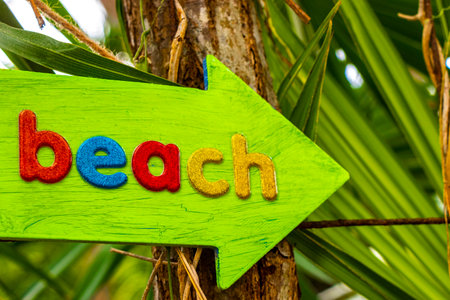 Directional signs sign on the beach in Playa del Carmen Quintana Roo Mexico.の写真素材