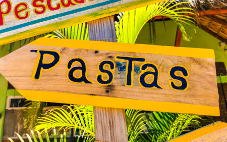 Colorful direction signs arrows to cafe bar or restaurant in Zicatela Puerto Escondido Oaxaca...