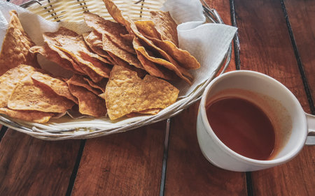 Mexican nachos in basket with sauce dispenser and limes in Playa del Carmen Quintana Roo Mexico.の写真素材